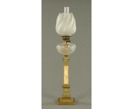 A Victorian brass Corinthian column oil lamp, with marble column and original shade, and a small booklet "Discovering Oil Lam
