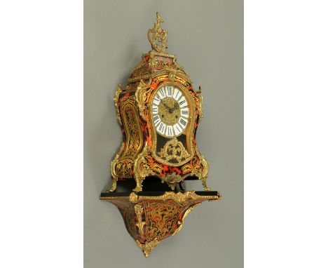 A Louis XV style bracket clock with bracket, simulated boulle marquetry, the clock with two-train striking movement.  Height 