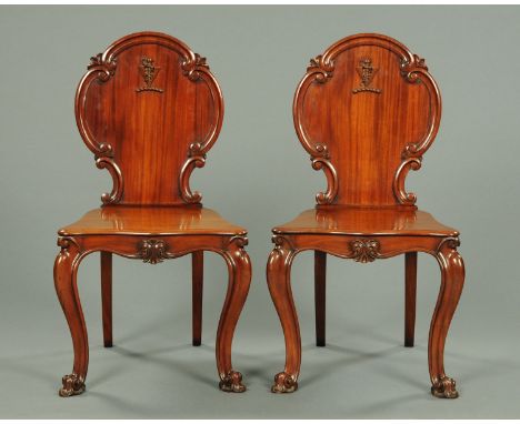 A pair of Victorian mahogany hall chairs, large form, with applied mouldings, solid serpentine fronted seats and raised on ca