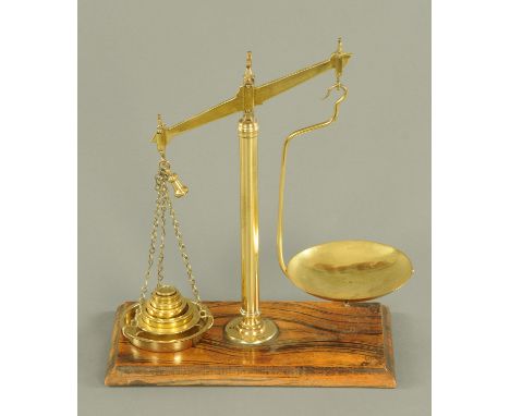 A set of Victorian balance scales, with weights, on simulated rosewood base.  