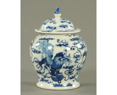 A 19th century Chinese blue and white lidded vase, decorated with lions.  Height 18 cm.    CONDITION REPORT:  The finial has 