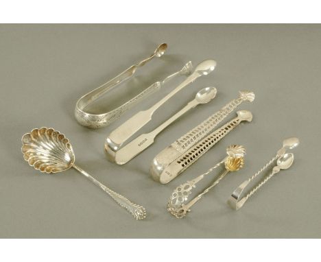 Five pairs of silver sugar tongs and a sifting spoon. 