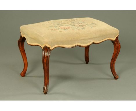A Victorian walnut dressing stool, serpentine outline, with tapestry upholstered top.  Width 75 cm. 