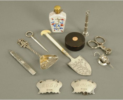 A silver cigar piercer, pencil holder, two wine labels, two shovels, silver brooch, silver skewer, cigar cutter, perfume bott