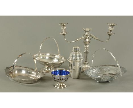 A silver plated cocktail shaker, candelabra, three baskets and sugar basin. 