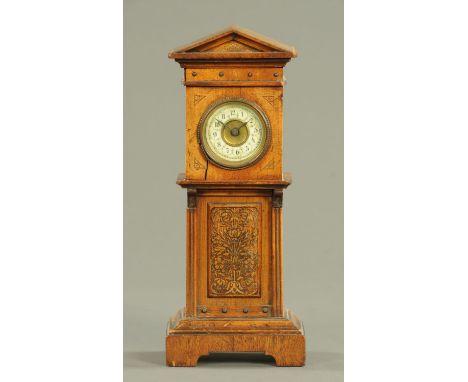 An Edwardian miniature grandfather clock, with single-train movement and raised on bracket feet.  Height 27 cm. 