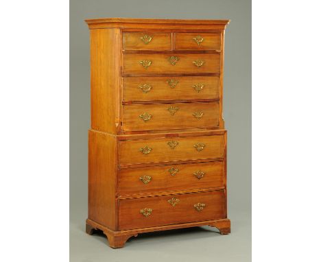 A George III mahogany tallboy, with moulded edge and canted angles to the upper half, fitted with two short and three long gr