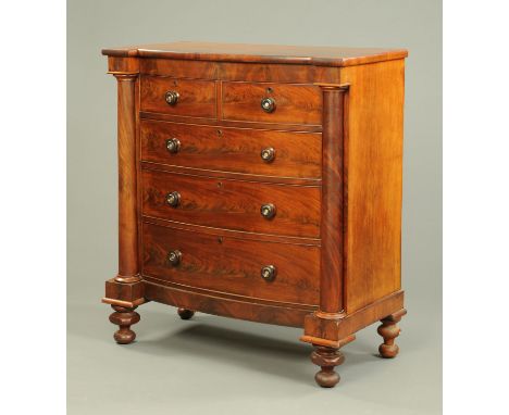 A Victoria mahogany bowfronted chest of drawers, with two short and three long graduated drawers with wooden knob handles fla