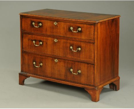 An 18th century walnut chest of drawers, boxwood strung, with moulded edge above three graduated drawers with brass drop hand