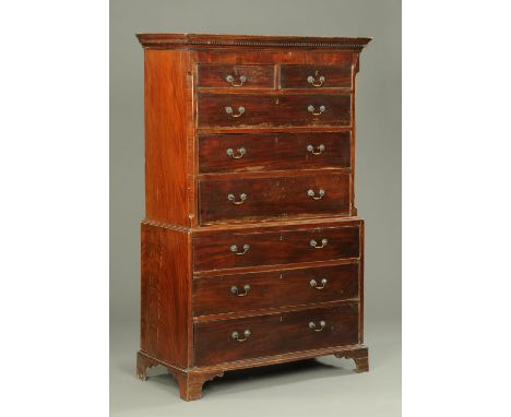 A George III mahogany tallboy, with moulded dentil cornice above two short and three long graduated drawers with brass drop h