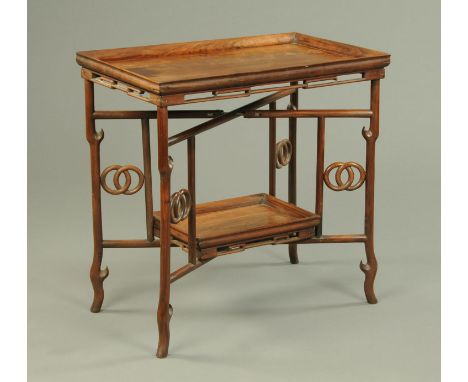 A Chinese hardwood side table, rectangular, with intricate supports and low shelf.  Length 76 cm.    CONDITION REPORT:  The t