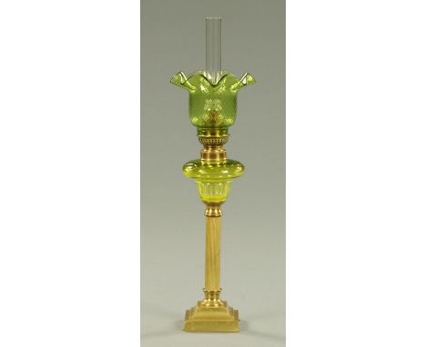 A small brass column oil lamp, with green glass reservoir and shade.  Height including chimney 51 cm.    CONDITION REPORT:  T