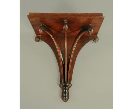 A Regency mahogany clock bracket, with scroll supports.  Width 33 cm, depth 22 cm. 