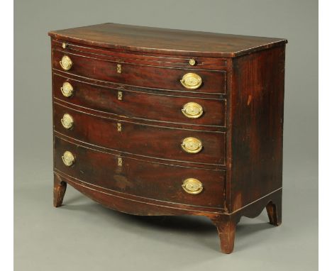 A George III mahogany bowfronted chest of drawers, with slide and four long graduated drawers with brass drop handles with ov