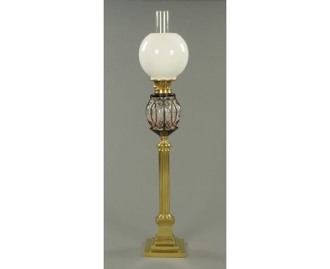 A Victorian brass oil lamp, with square stepped base.  Height including chimney 92 cm. 
