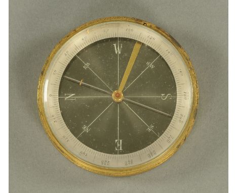 An antique travelling brass compass, circular.  Diameter 78 mm. 