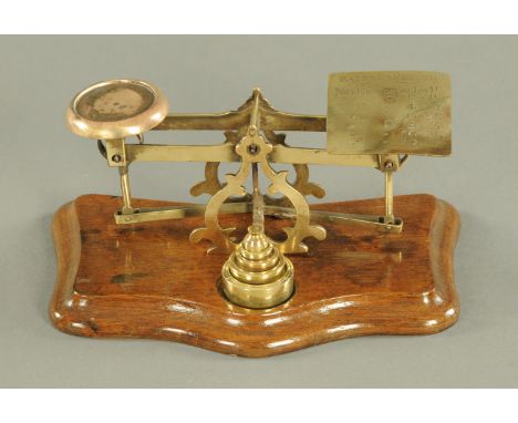 A set of Edwardian brass postal scales, with weights.