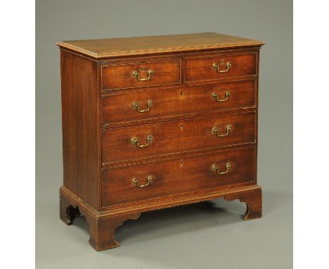 A George III oak chest of drawers, two short and three long drawers with brass drop handles and cockbeading to each drawer fr