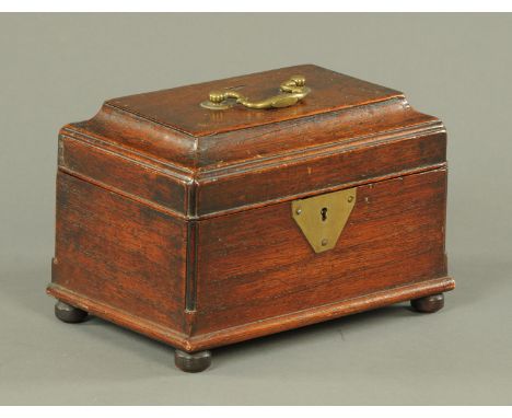 A Georgian mahogany tea caddy, with brass handle and lock escutcheon and raised on short bun feet.  Width 25 cm. 