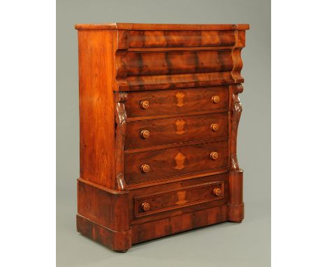 A Victorian mahogany Scotch chest on stand, with two serpentine drawers above four further drawers with wooden knob handles a