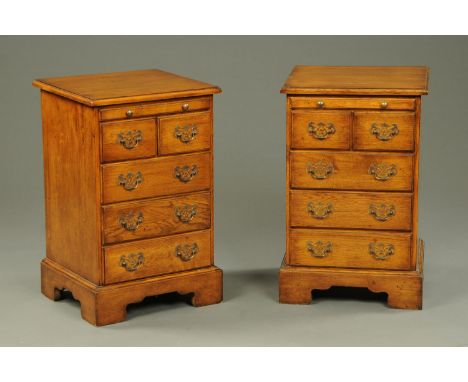 A pair of oak chests of drawers, small size, with moulded edge, slide, two and three long graduated drawers with brass drop h