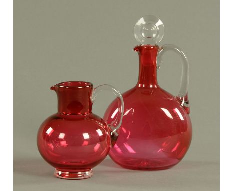 A Victorian cranberry glass decanter, with stopper and a jug. Tallest 24 cm.    CONDITION REPORT:  