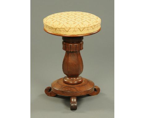 A William IV rosewood stool, with circular top, with adjustable mechanism and raised on three scroll feet.  Diameter 37 cm.  