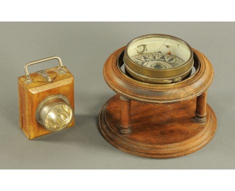 A brass yacht compass, in oak stand, and an Eveready lamp.  Compass stand diameter 24 cm. 