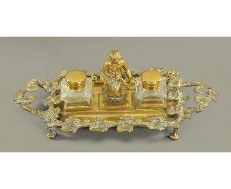 A Victorian brass combined pen inkwell and watch stand.  Length 33 cm. 