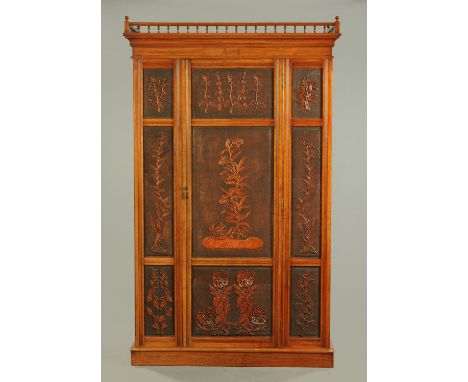 An Edwardian carved walnut wardrobe, with Japanese influence carved panels, detachable moulded cornice above a single door op