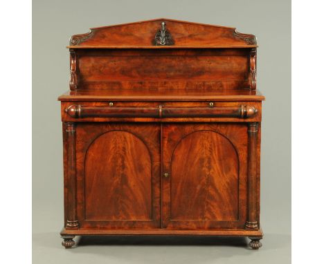 An early Victorian mahogany chiffonier, with rear upstand and shelf,  fitted with two frieze drawers and pair of panelled cup