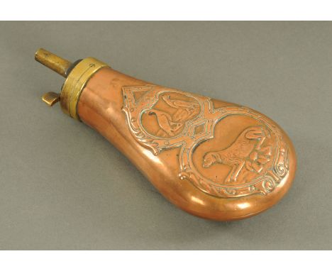 A Victorian copper and brass shot flask, with dog and bird relief moulding.  Height 16 cm. 