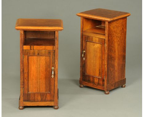 A pair of rosewood bedside cabinets, with moulded edge, shelf, single door and raised on bun feet.  Width 34 cm.    CONDITION