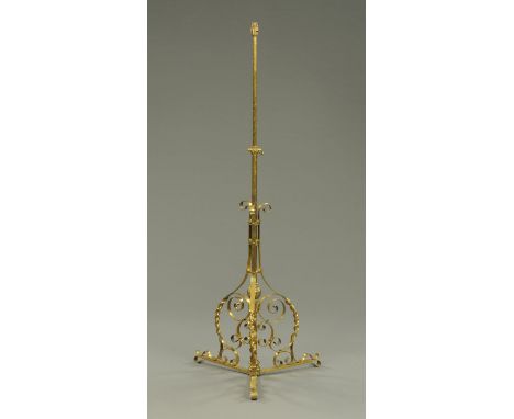 A Victorian lamp standard, adjustable, with scroll support.