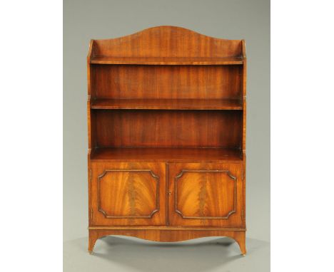 A Bevan Funnell Reprodux bookcase, with panelled cupboard doors and raised on bracket feet.  Width 83 cm.    CONDITION REPORT