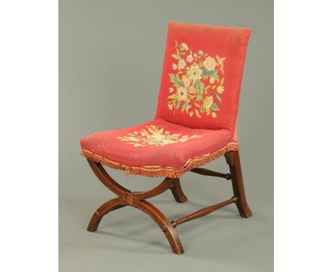 A Victorian chair, with tapestry back and seat and with Klismos supports beneath.  