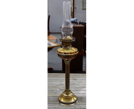 A brass oil lamp, together with a pair of ceramic floral ceiling lamps