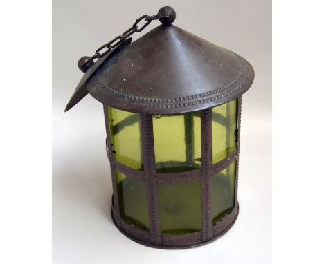 A hanging lantern with green glass