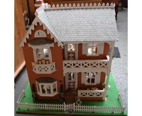 A early 20th century model of a dutch with garden and pallisade fence, vegetable patch and fitted interior and furnishings to