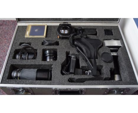 A Leica R4 camera with a selection of Leica lenses and accessories in a flight case: A Sumicron-R 1:2/50 Leitz lens, a Metz 4