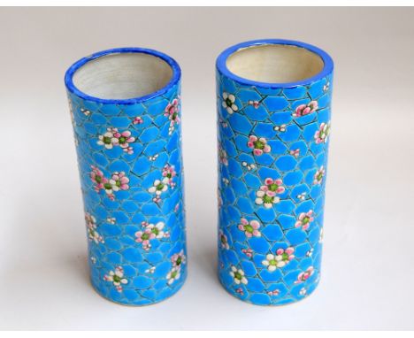 A pair of ceramic vases decorated with flowers