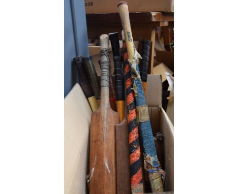 A selection of vintage sports equipment: five tennis raquets, two squash raquets, two hockey sticks and two cricket bats