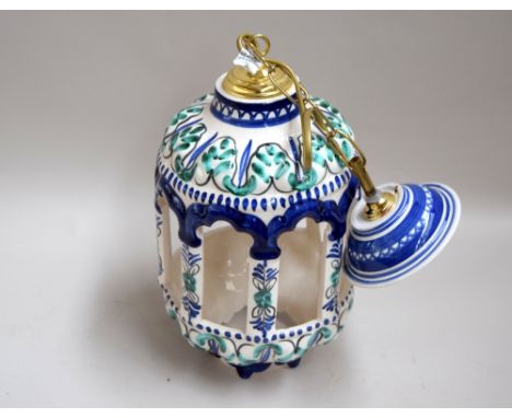 A handpainted ceramic hanging lampshade, blue and green decoration with cut out sections, 33cmL