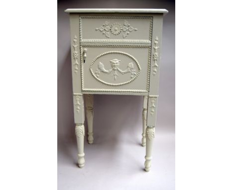 An Adam style painted pot cupboard decorated with a Satyr's mask and a Louis XVI style petite commode