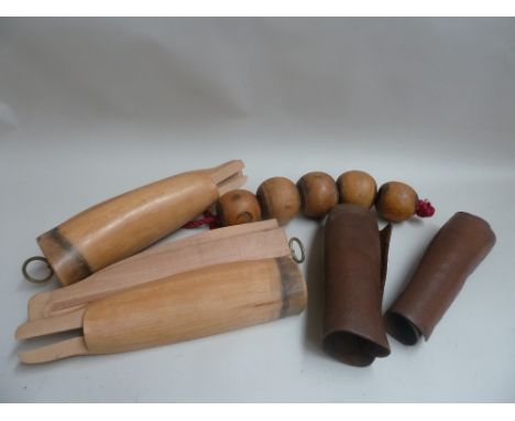 A pair of wooden trees (feet missing); a pair of leather gaiters and 5 lignum vitae "tie-up bobbins" or "manger balls"