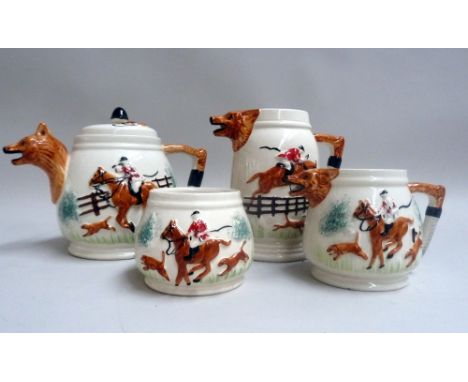 A four piece porcelain tea set with a fox hunting motif and with handles and spouts in the shape of fox masks and brushes (4)