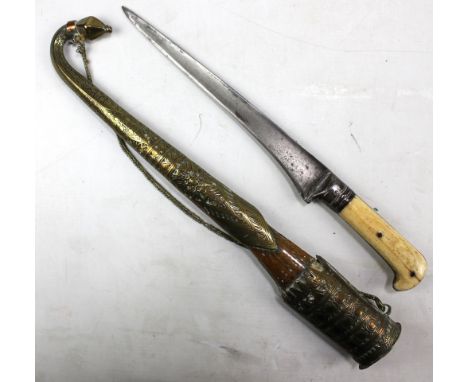 A bone handled Eastern dagger with brass mounted scabbard, length 44cm. CONDITION REPORT: Regarding scabbard; brass fittings 