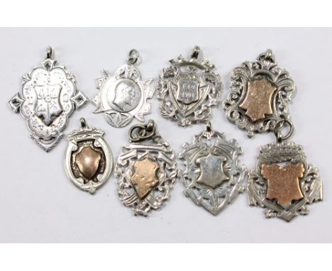 Six variously hallmarked silver fob medallions with vacant cartouches, to include examples by William Hair Haseler, 1913, and