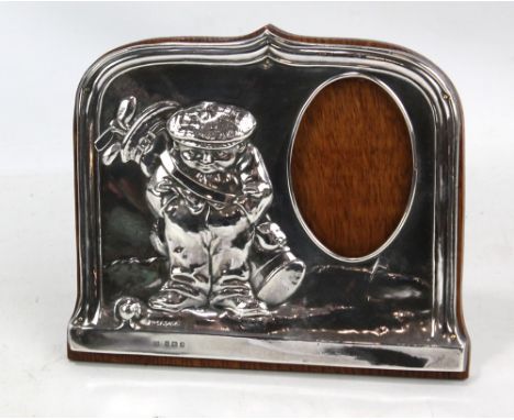 ROBERT PRINGLE &amp; SONS; a George V hallmarked silver fronted photo frame embossed with a caricatural figure of a golfer, B