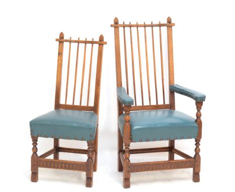 NIGEL GRIFFITHS; a set of twelve reproduction oak stick back dining chairs with padded stuffover stud decorated seats and tur
